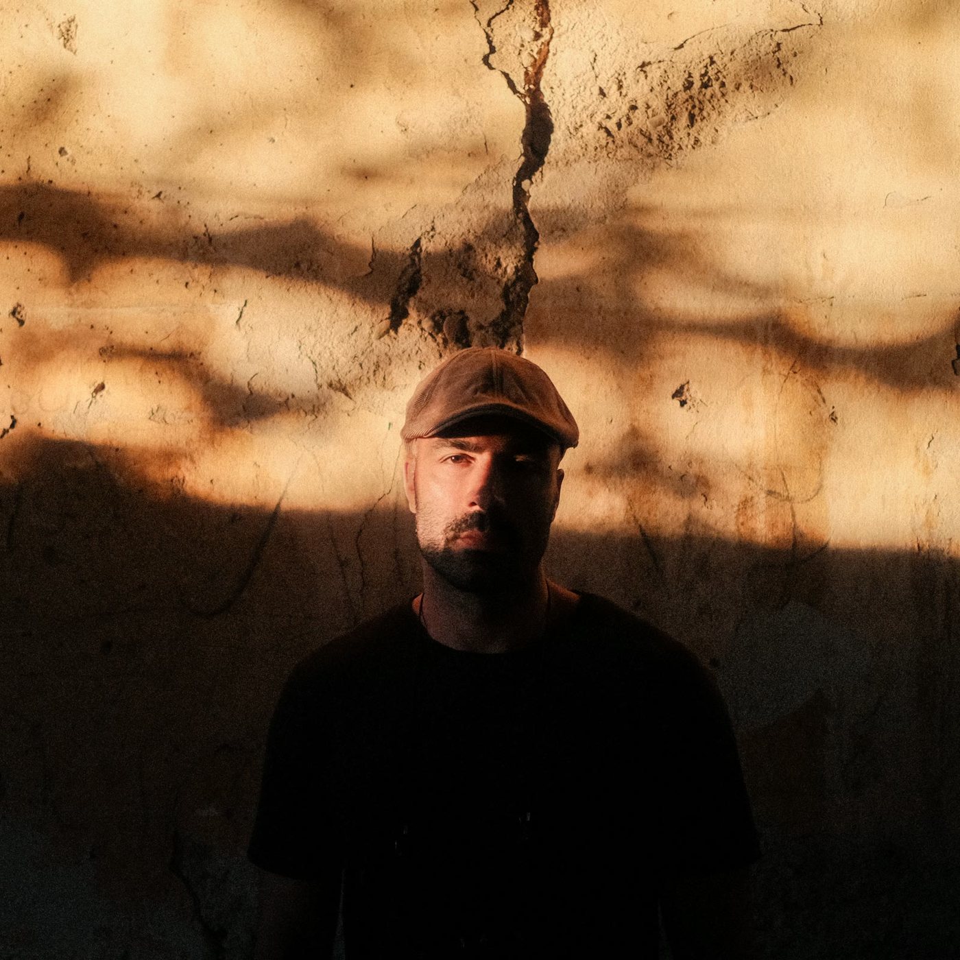 Vasilis Tsapopoulos against a sunlit wall